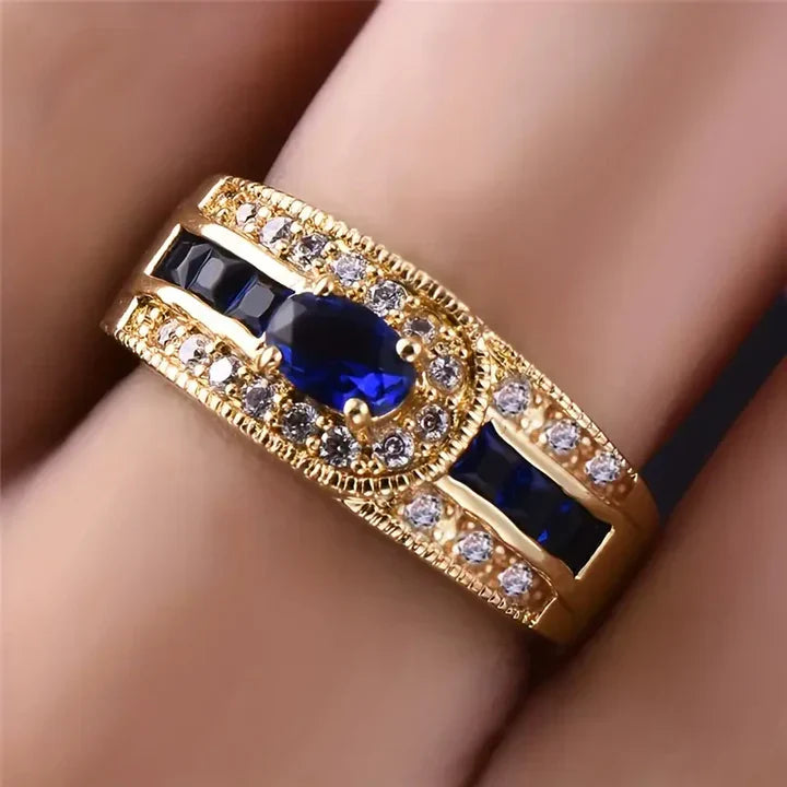 Brilliantblå ring i guld